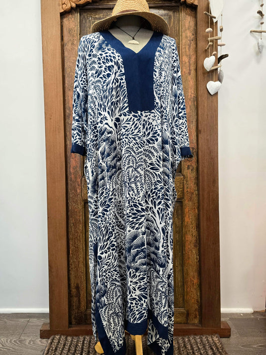 Gorgeous navy blue kaftan with multiple tree designs on a mannequin