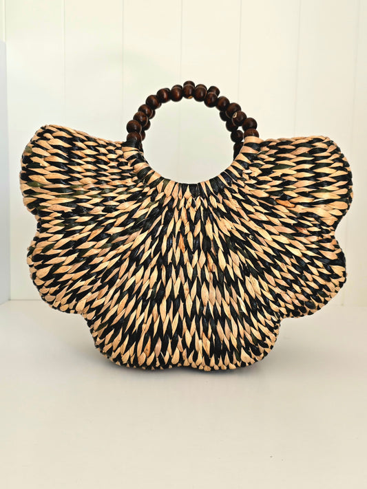 Black and natural colour water grass woven together in scallop shape with beaded rounded handles