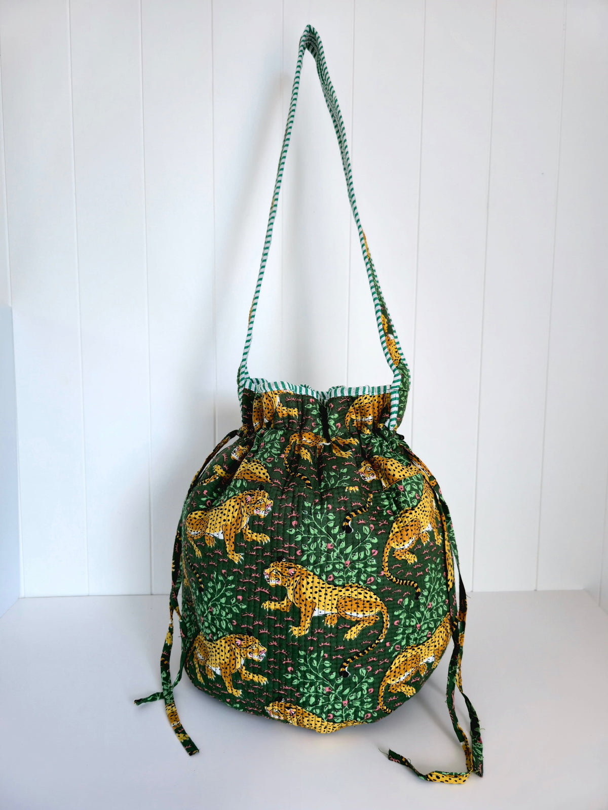 Drawstring cotton kantha bag with leopard print on a white background
