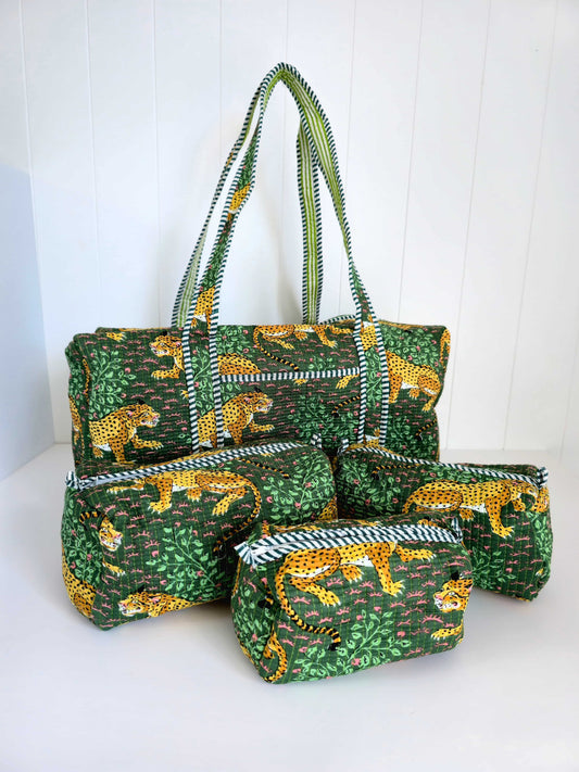 Set of green bags weekender and pouches with animal pattern on a white background