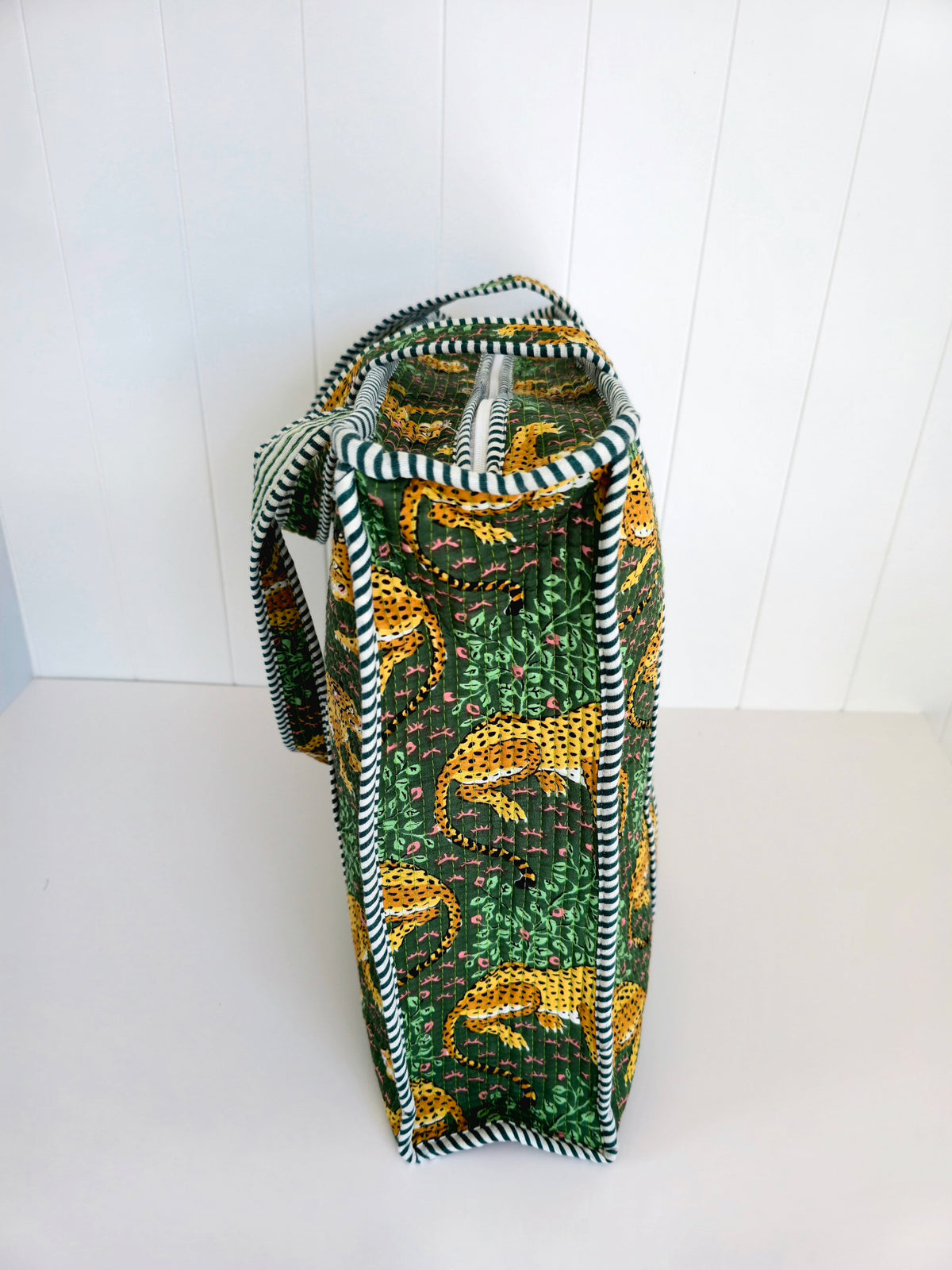 Tote bag with leopard pattern on a white background looking the side view