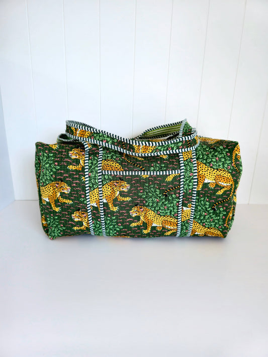 Green weekender bag with gold leopard pattern on a white background