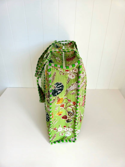 Green floral botanical patterned bag from the side view on a white background