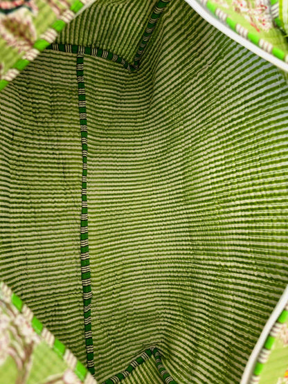 Close-up of the inside of a green woven bag with a floral patterned background