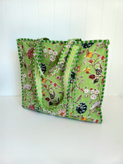 Green floral botanical patterned square tote bag on a white background
