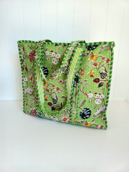 Green floral botanical patterned square tote bag on a white background