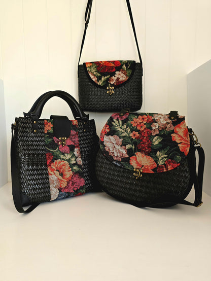 Three floral-patterned hand woven handbags on a white background